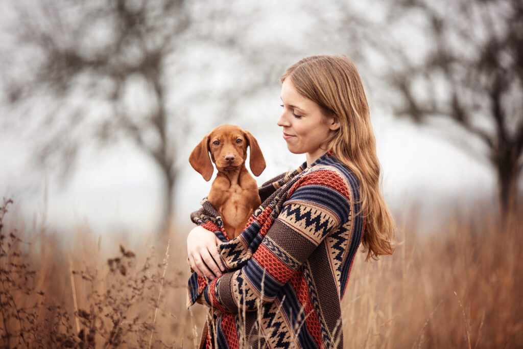 Frau kuschelt mit Welpe bei Welpenfotoshooting mit Coralie Duda Fotografie im Wetteraukreis